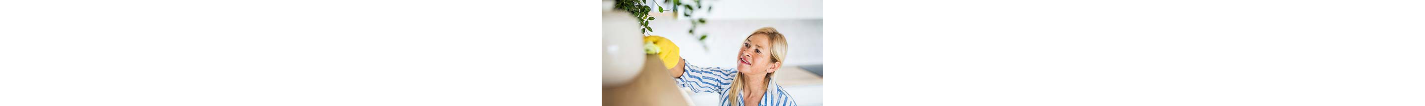A woman wiping down a shelf.