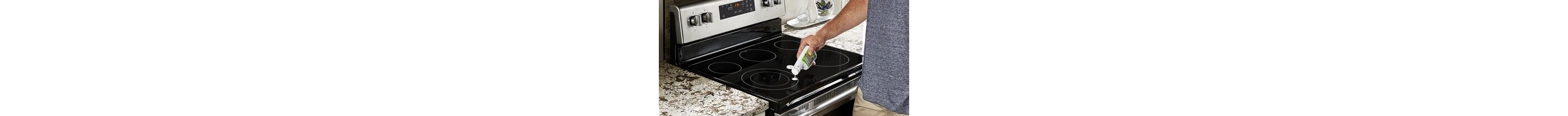 A person cleaning a glass stovetop with affresh.