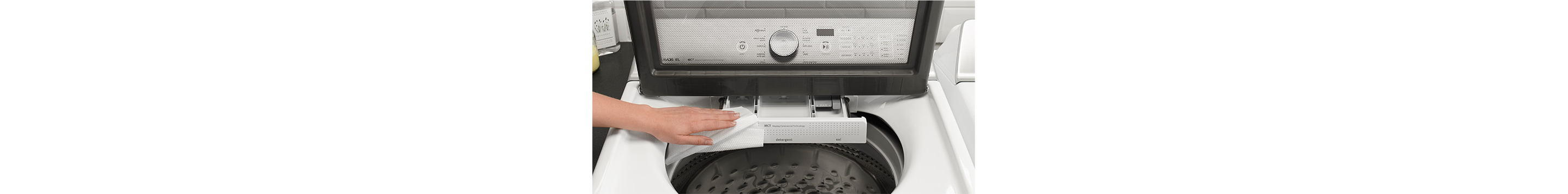 A person cleaning a washing machine.