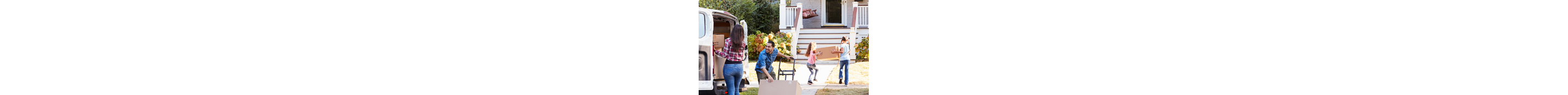 A family carries moving boxes into their new home.